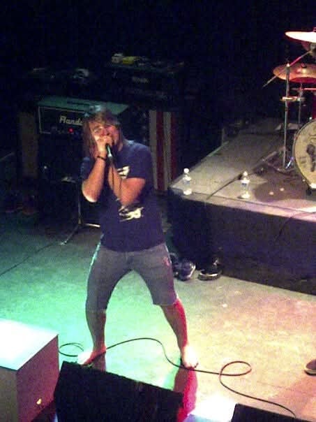 Man performing on stage at a live music show