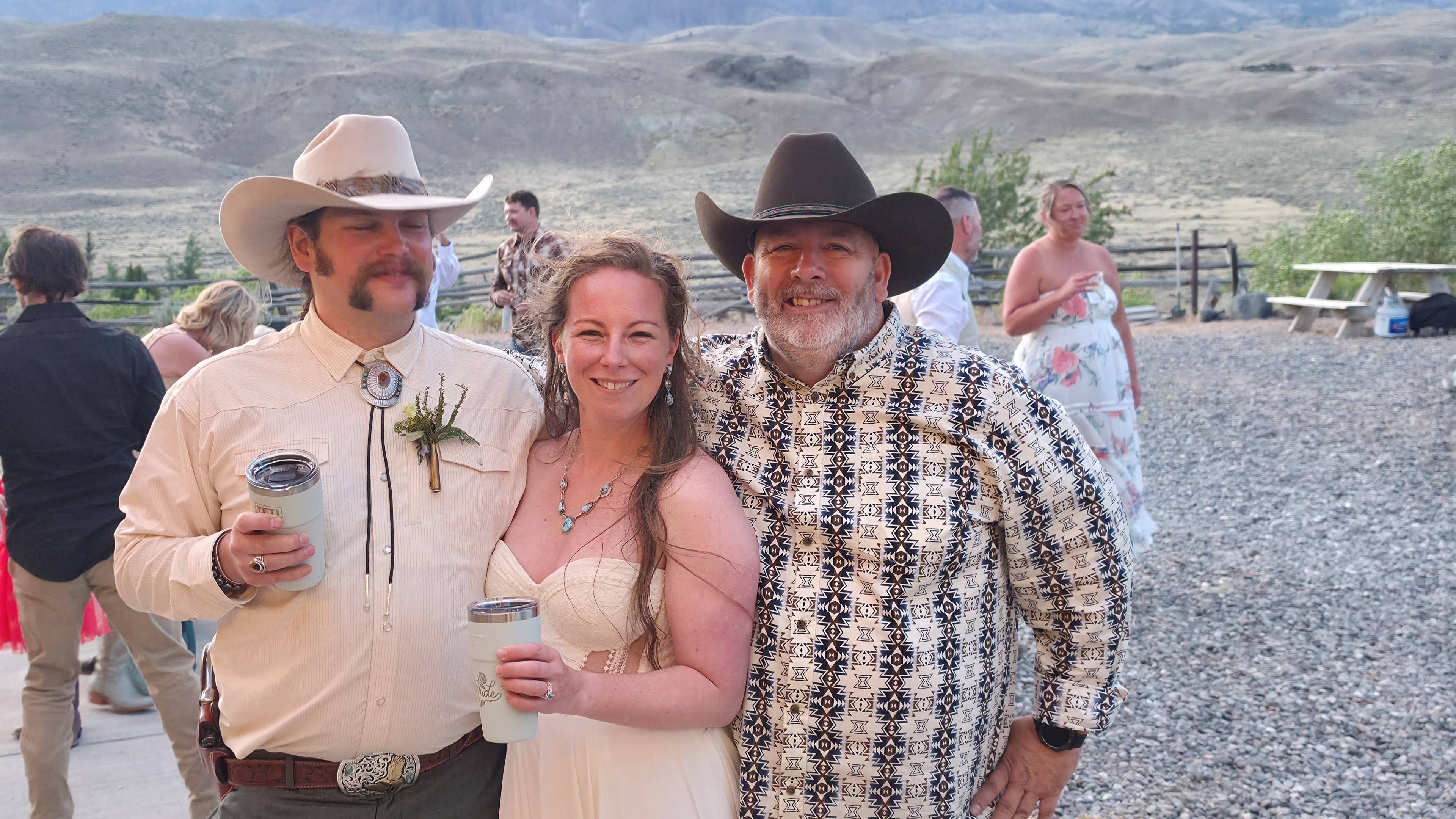 Three people in cowboy attire at ranch party