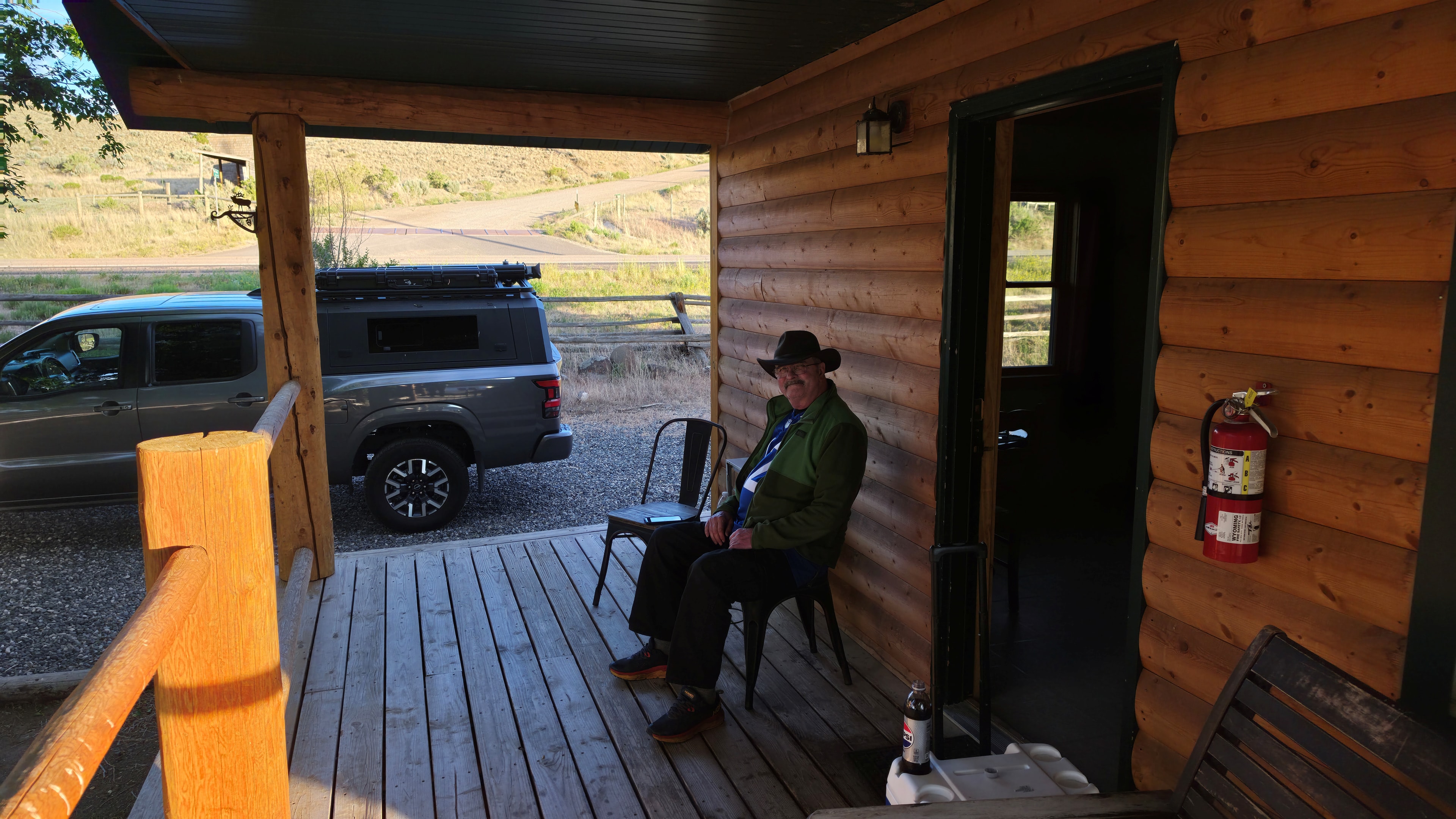 Man relaxing on log cabin porch