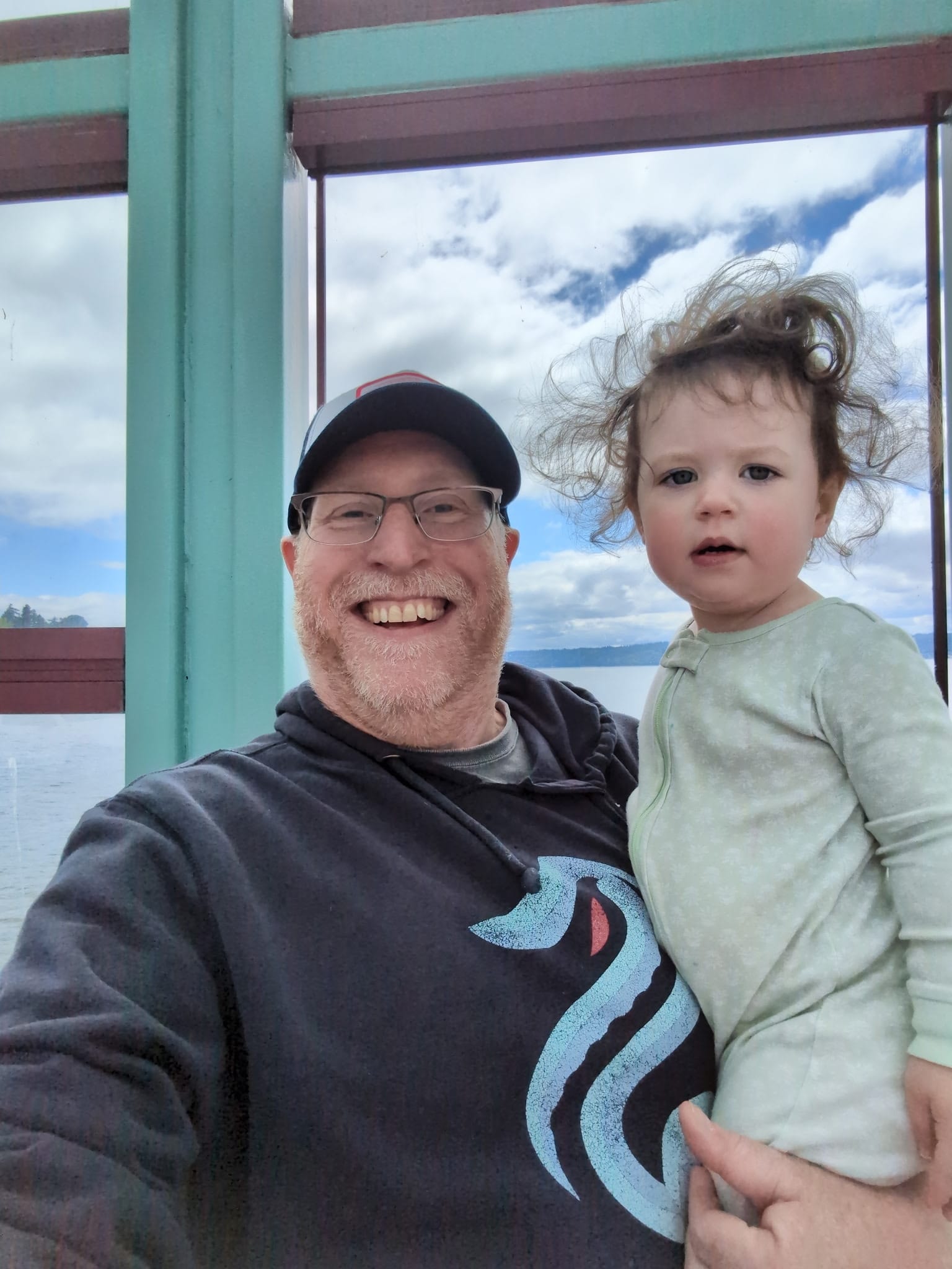 Man holding toddler by lakeside window