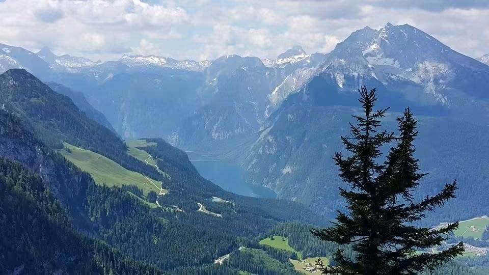 Alpine valley with lake and mountain peaks viewed from above the treeline